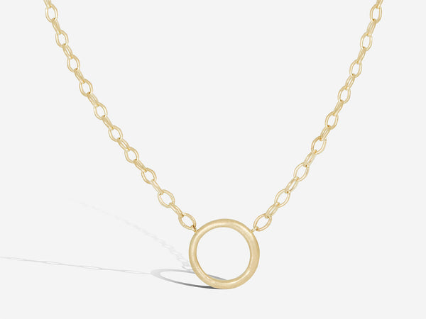 An organic, textured circle sits between two passages of wide oval chain