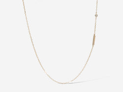 Bottom half of hanging necklace showing a small offset gold rectangle set within the chain, with a diamond bling set slightly above it.