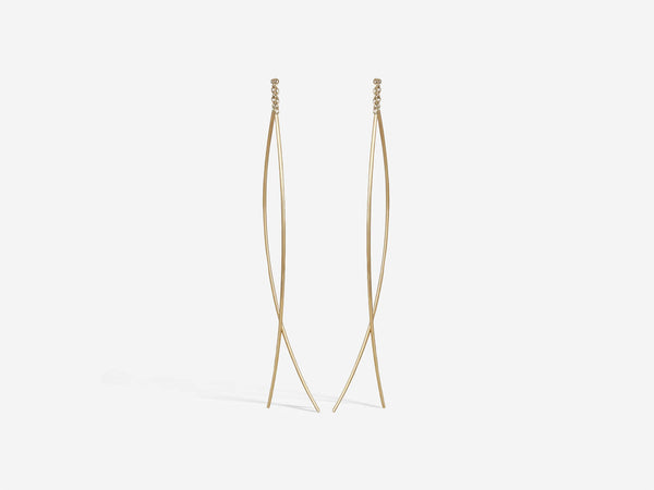Two curved segments of 14k gold wire are connected by a half inch of gold chain. Medium size