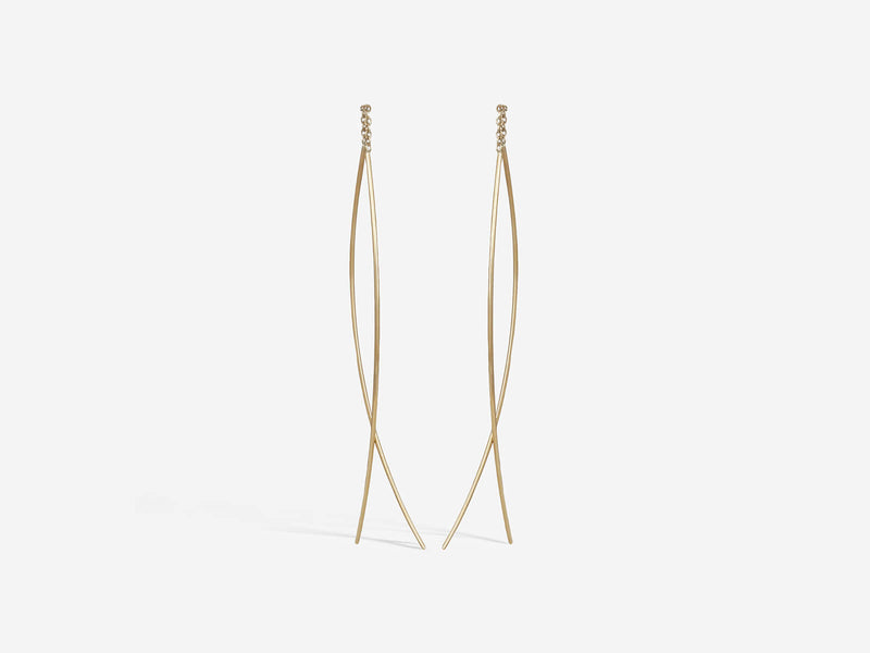 Two curved segments of 14k gold wire are connected by a half inch of gold chain. Medium size