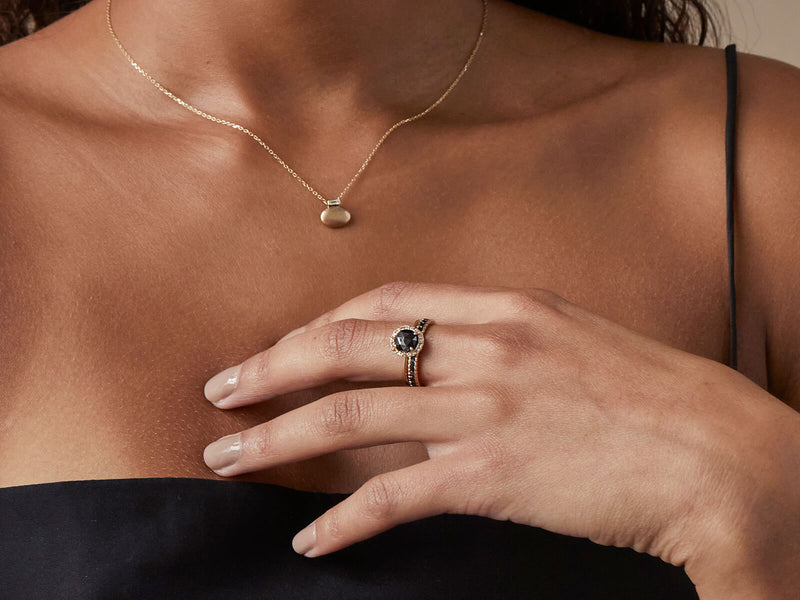 Model wearing ring stacked with Large Textured Infinity Band