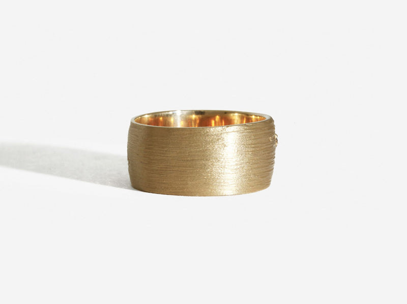 Back view showing horizontal, groove like texturing across the entire width of the ring