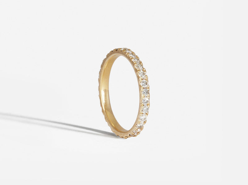 Three-quarters silhouette view of ring showing high polished interior edge and pave setting of diamonds