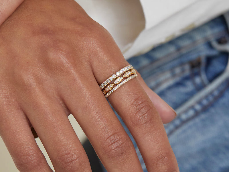model wears 2 mm eternity band, diamond wave stack ring, and 1 mm eternity band on pointer finger