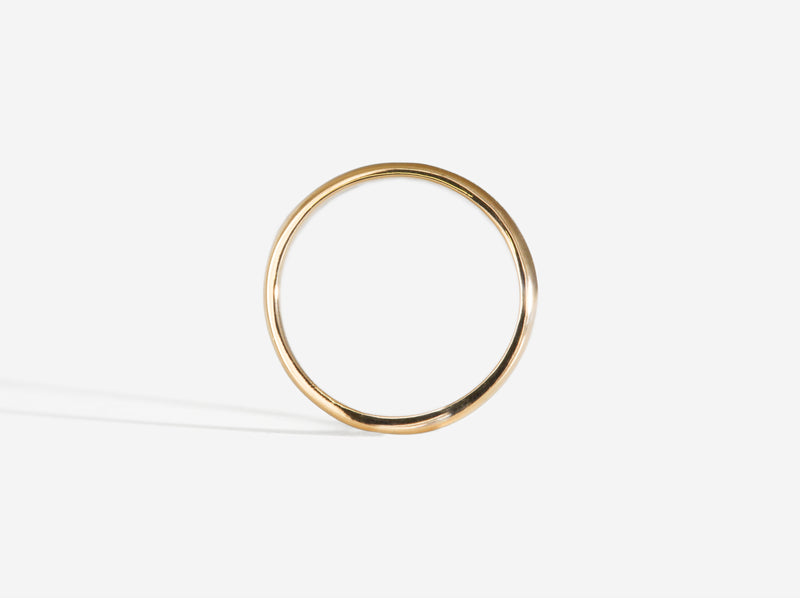Silhouette view of ring to show flat inner edge and curved outer edge
