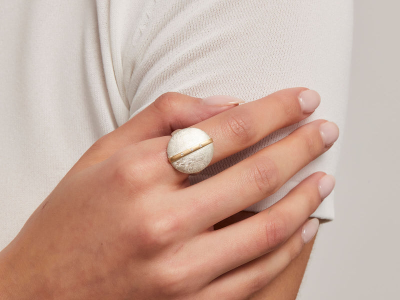 model wearing vertical bar coin ring with white diamonds