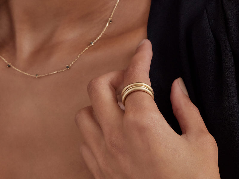 Model wearing the three bands on one finger