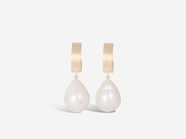 Front view of hanging huggie hoops with pearl drop earrings