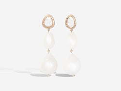 Front view of earrings. Diamond slice is at the top with a small pearl hanging underneath and a slightly larger pearl under the smaller one