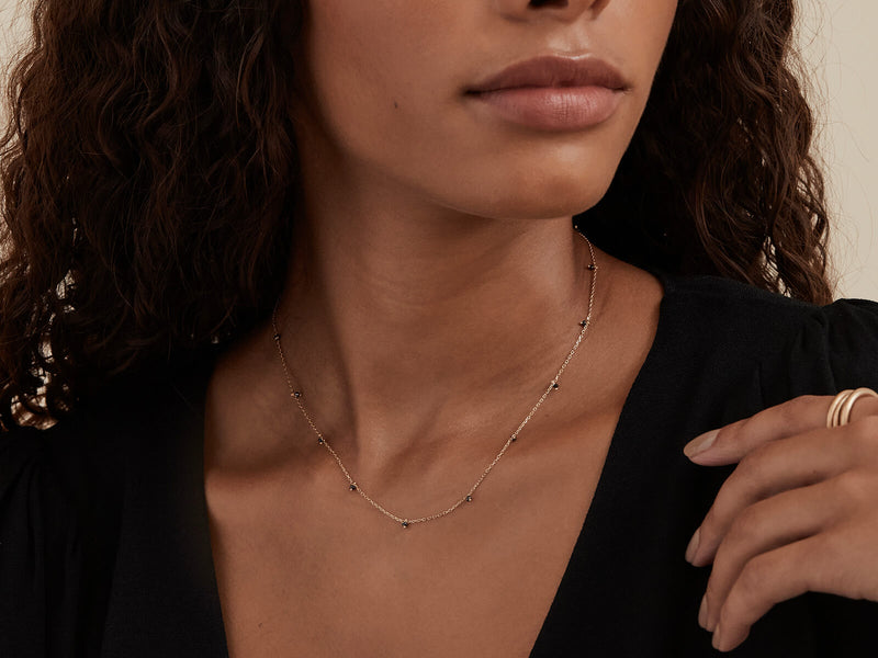 Model wears necklace to show sixteen inch length and glimmering chain