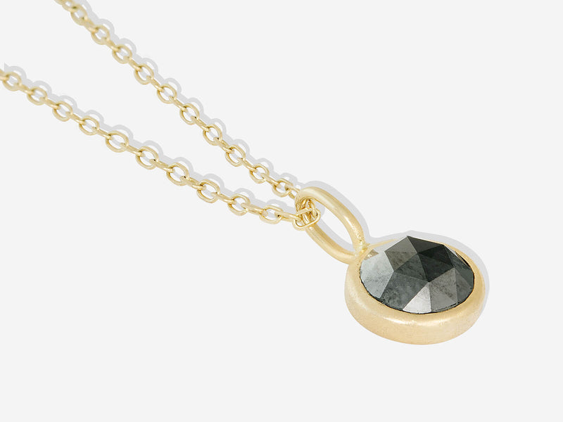 Detail shot of pendant with necklace laying flat