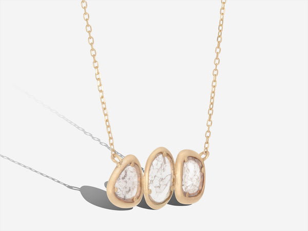 Three quarters hanging view of Trio Necklace