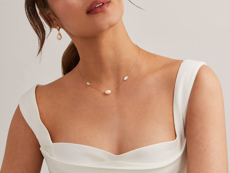 model wears pearl and diamond slice necklace