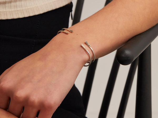 model wears mixed metal flamenco cuffs