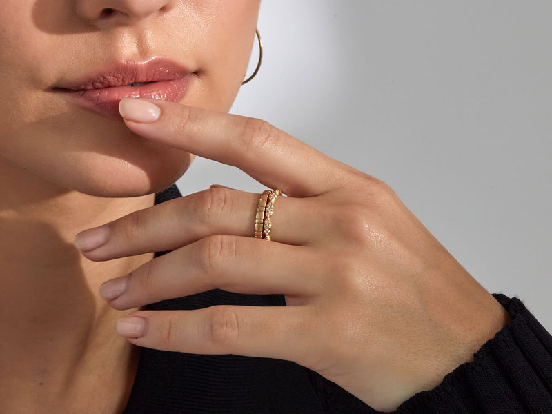 model wears wave stack ring with diamonds