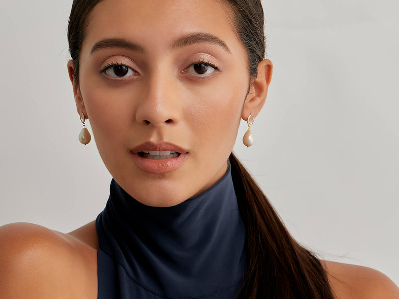 Model wearing diamond slice pearl drop earrings