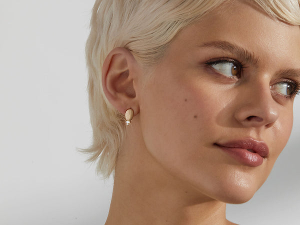 close up of model wearing earring