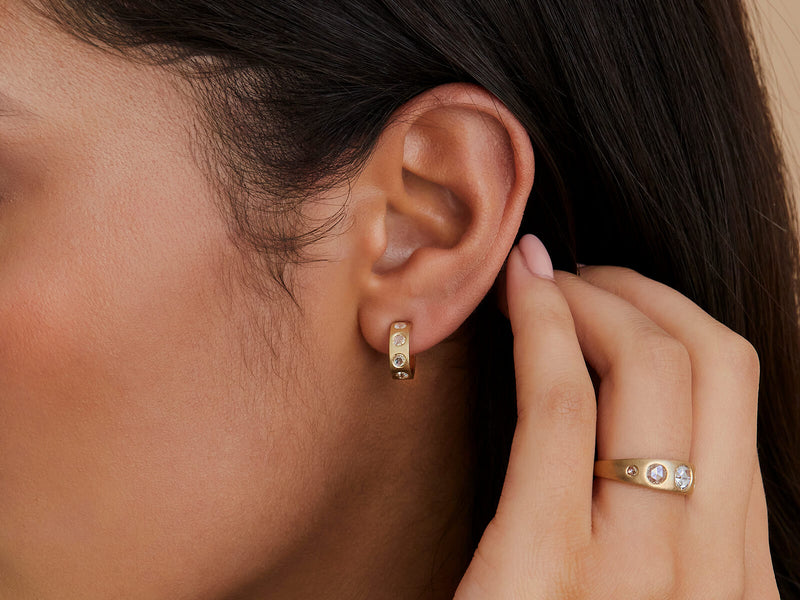 Close up of model's ear wearing earring