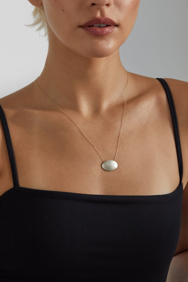 close up of model wearing necklace