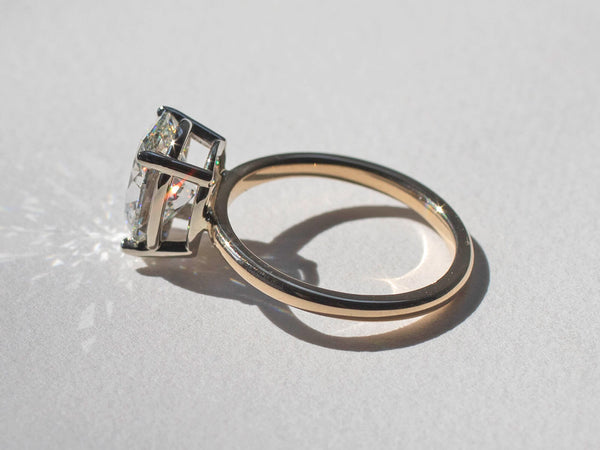 Profile view of ring showing the basket and sparkling diamond